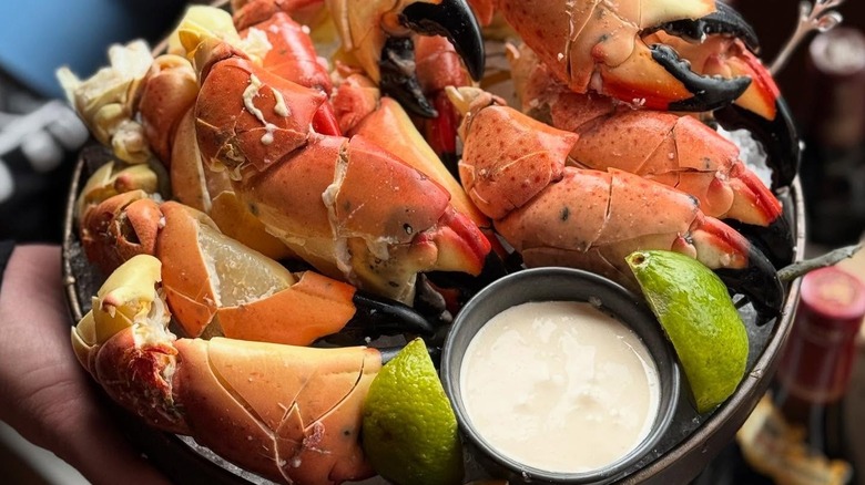 Stone crabs with lemon wedges and sauce