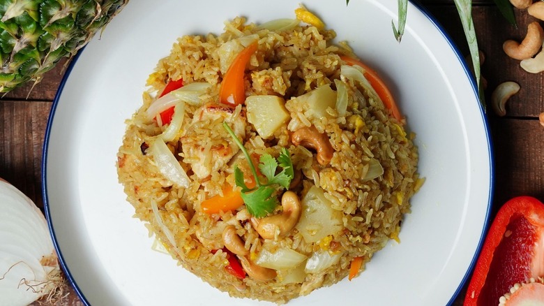 Fried rice with pineapple and cashews on plate at The Secret Sauce Thai Kitchen