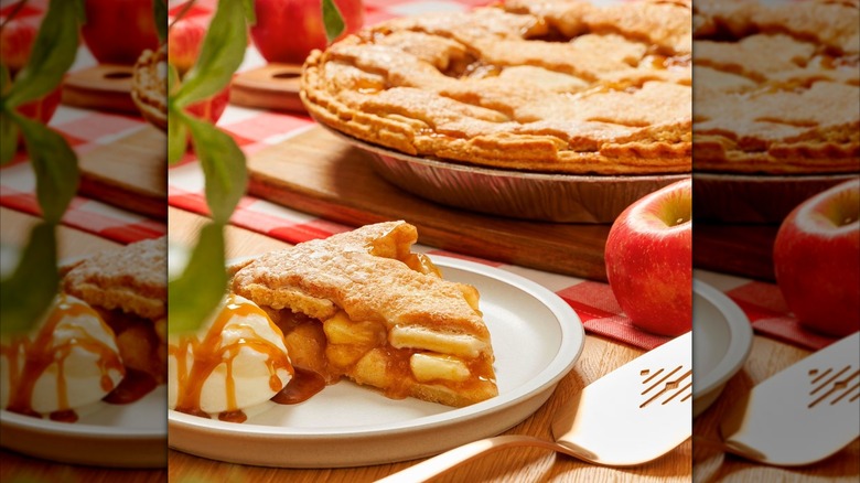 Slice of apple pie on plate with ice cream and pie in background