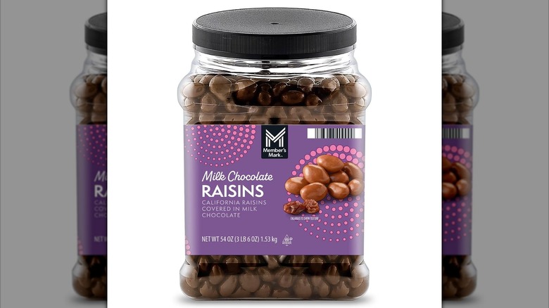 Large plastic container of milk chocolate raisins