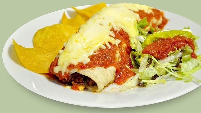 Burrito covered with salsa and melted cheese