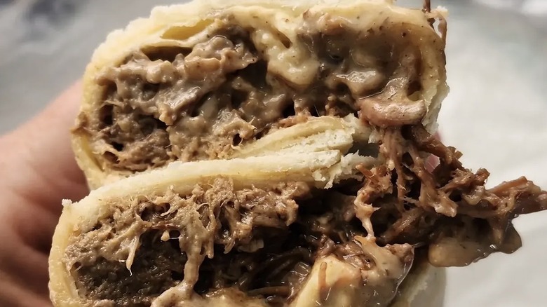 Burritos filled with beans and cheese, and brisket and cheese