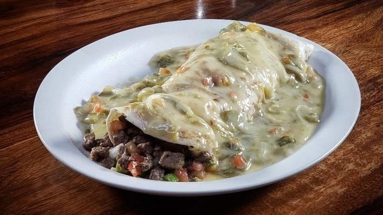 Steak burrito smothered with chili con queso