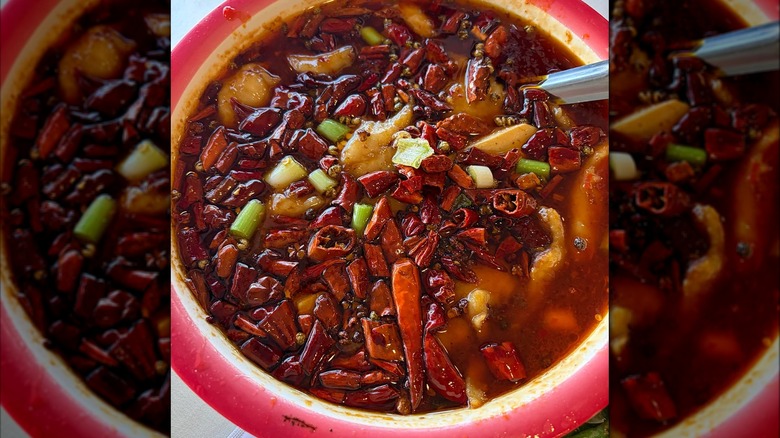 Stewed fish with hot peppers in a red bowl