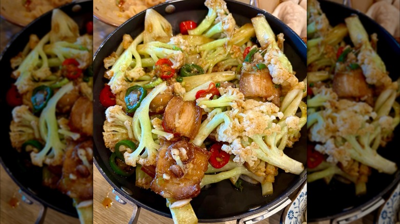 Cauliflower and pork in a pot on a wooden table at Good Alley