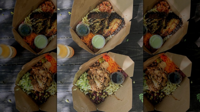 Top-down shot of takeout boxes from Irie Island Eats on wooden table