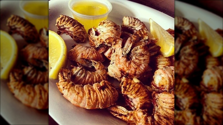 Rock shrimp on plate with lemon wedges and melted butter