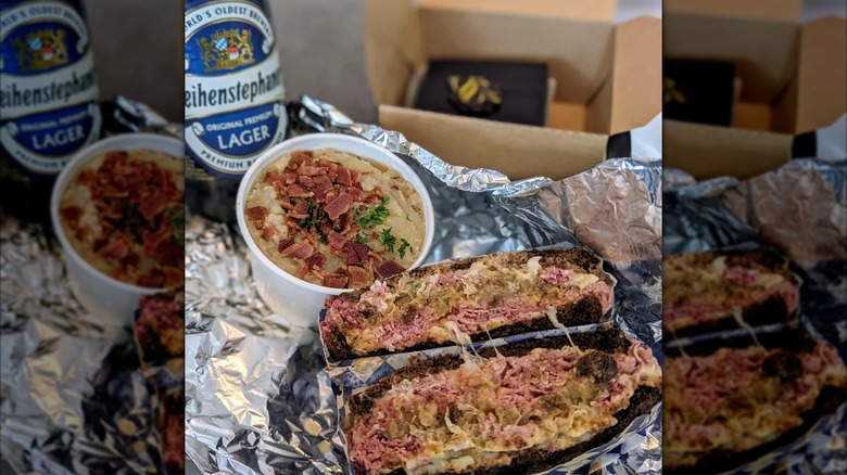 Reuben with container of German potato salad and bottle of beer