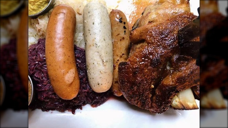 Sausages and pork shank with cabbage and sauerkraut