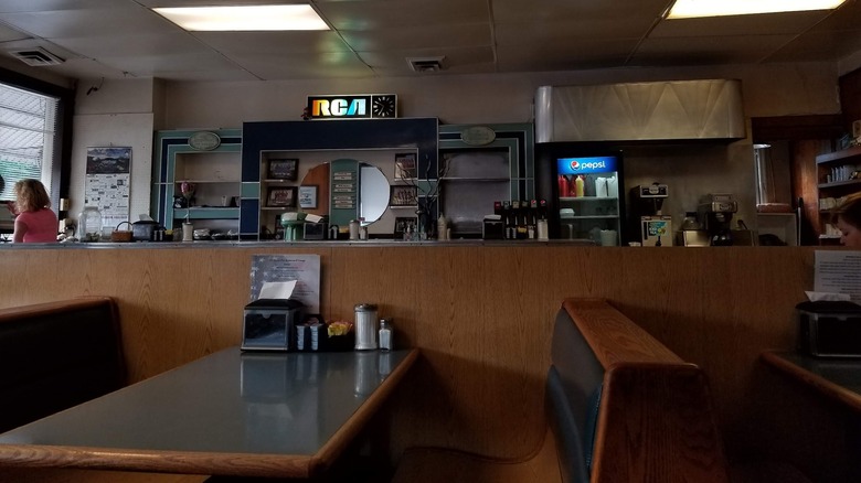 Diner interior with booths and RCA sign in the back