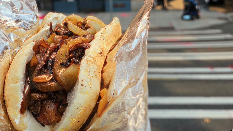 person holding a hot dog from Deez Dogs in Seattle