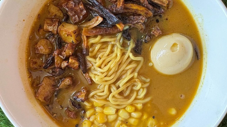 Bowl of curry ramen with potatoes, carrots, and corn