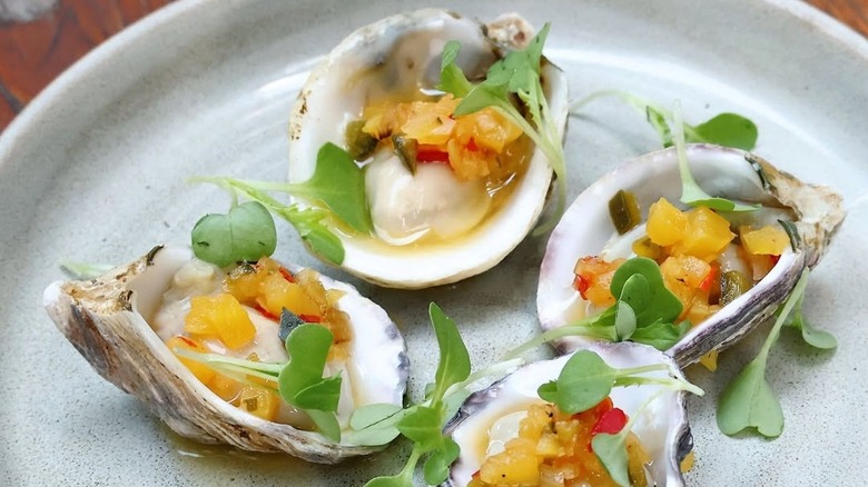 Plated half-shell oysters with giardiniera mignonette and ponzu sauce