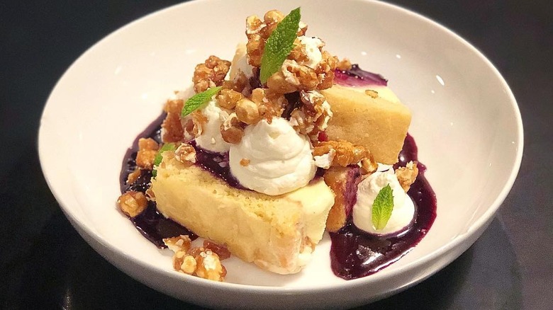 Plate of cornmeal cookie, vanilla ice cream, whip cream, caramel popcorn