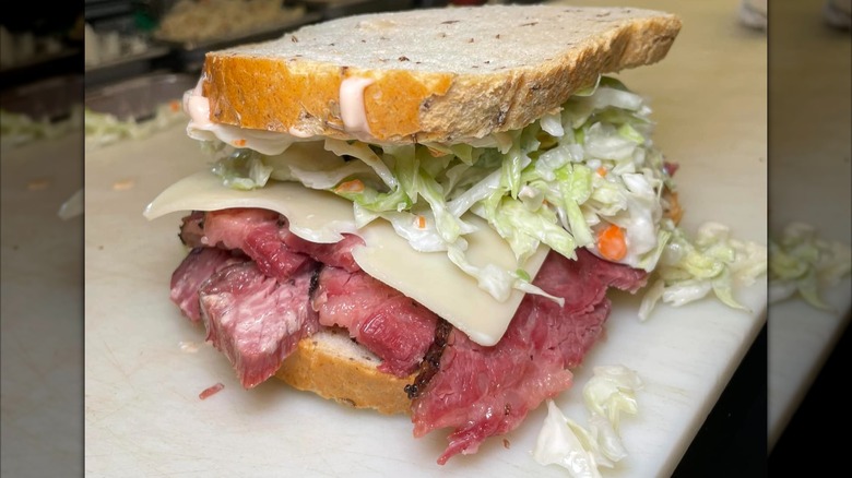 Pastrami sandwich on rye with lettuce and Swiss cheese