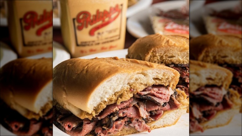 Half of a pastrami sandwich with hot mustard