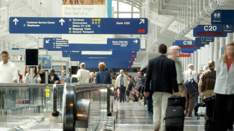Travelers walking through terminal at O'Hare International Airport