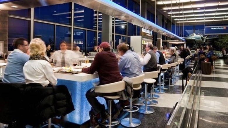 Customers dine at the bar in the airport terminal