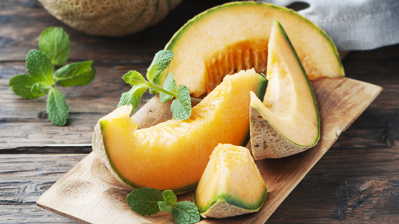 Sliced canteloupe on cutting board