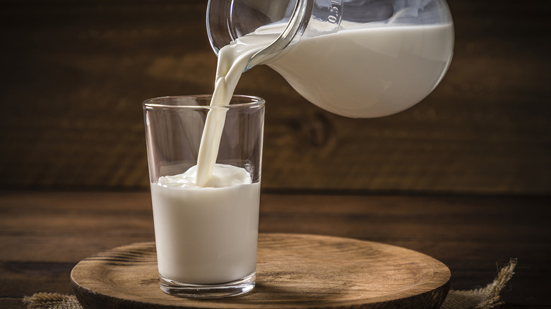 Pouring milk into a glass from a pitcher