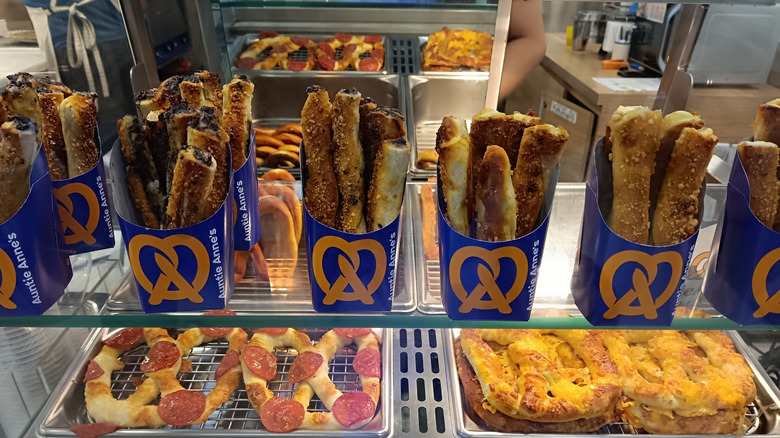 An Auntie Anne's pretzel display in a bakery case
