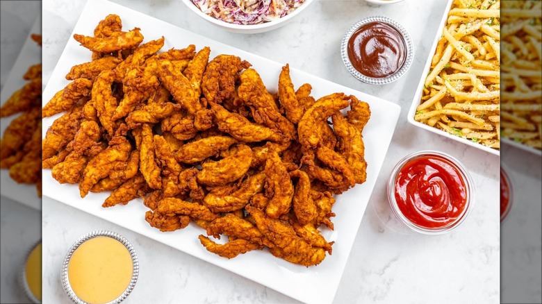 City Bird chicken being dipped in sauce