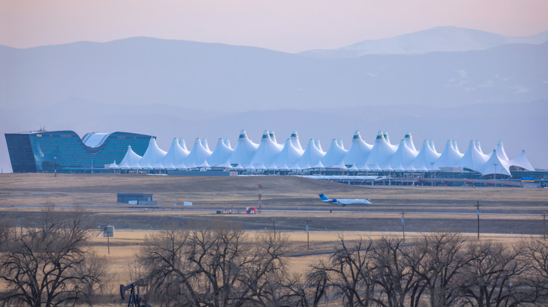 Denver airport white tents with Rocky Mountains behind