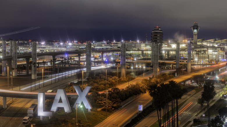 LAX sign in front of Los Angeles airport at night