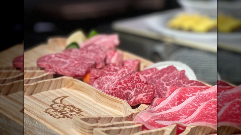 Slices of Wagyu beef on a wooden board