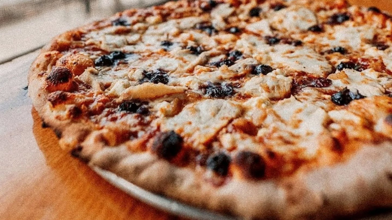 Pizza on a plate by a window