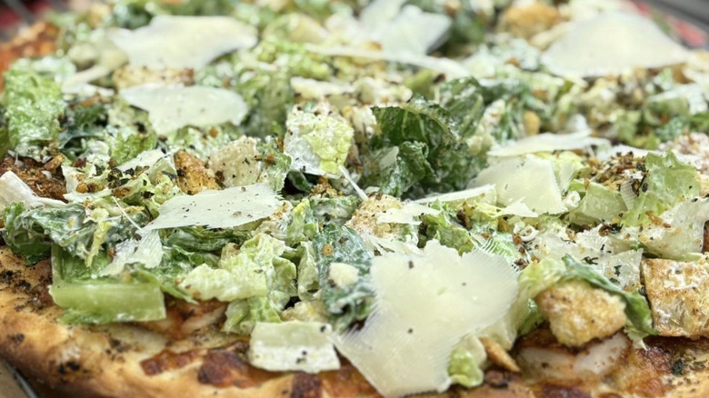 Pizza from Roseland topped with lettuce and croutons