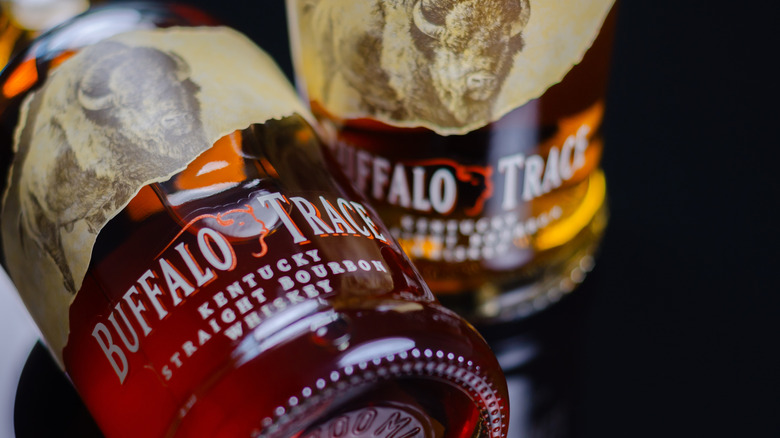 A close up of two bottles of Buffalo Trace, with one laid on its side