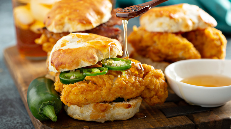 Fried chicken biscuit sliders with honey drizzle and jalapenos