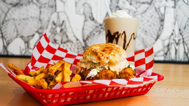 Chicken biscuit with fries on red tray with milkshake