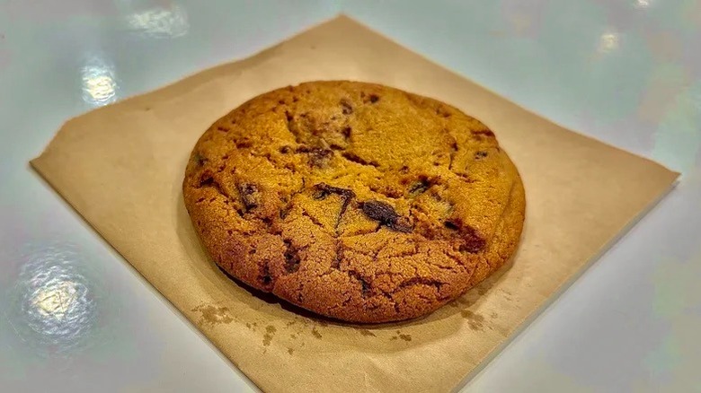 Costco food court double chocolate chunk cookie on a natural napkin on a food court table.