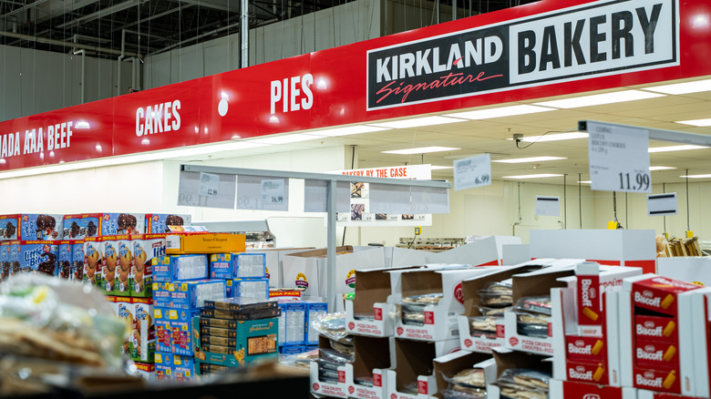 Costco Kirkland Signature Bakery signage with stacks of sweet inventory set up in front.