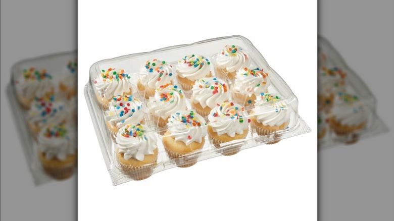 Costco Kirkland Signature white cupcakes with white buttercream frosting in clear plastic bakery container