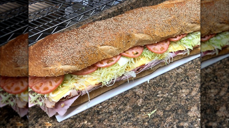 Cheese and meat sandwich with lettuce from Sal, Kris, & Charlie's Deli on a countertop