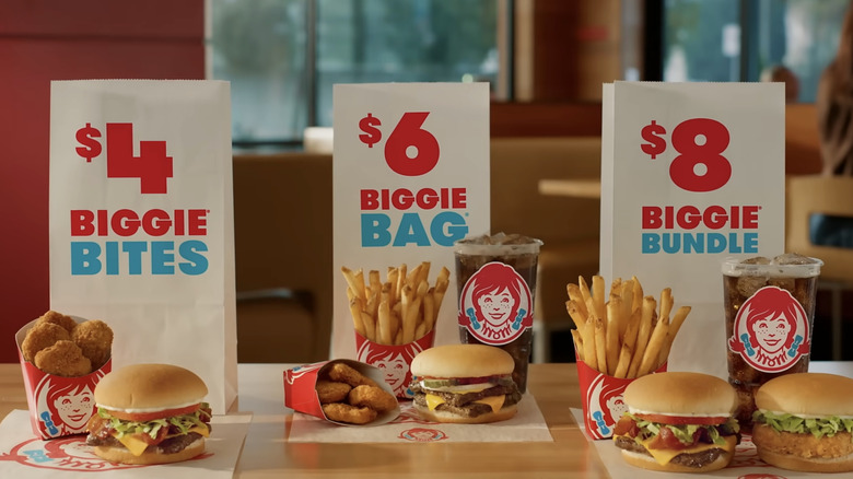 Wendy's $4 Biggie Bites, $6 Biggie Bag, and $8 Biggie Bundle deals laid out on a table in the restaurant