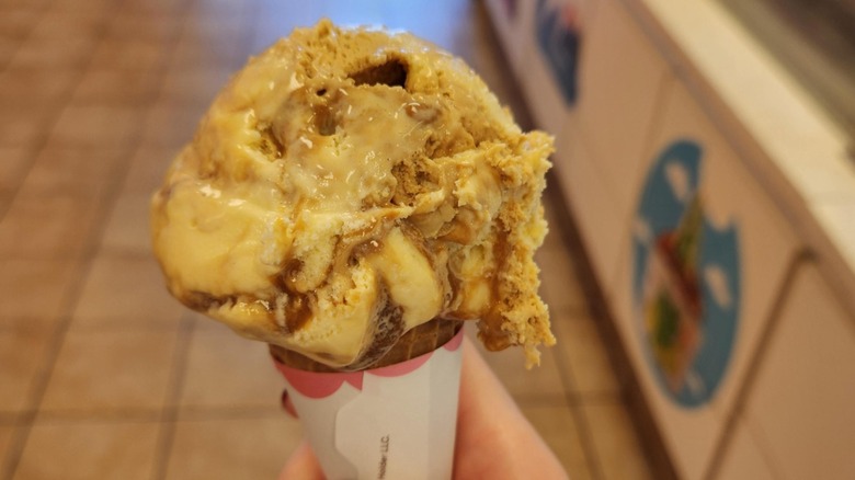 An ice cream cone with a big scoop of banana dulce de leche ice cream