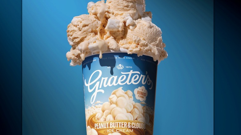 A pint of Graeter's Peanut Butter and Clouds ice cream with the ice cream piled on top