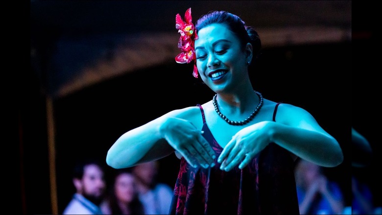 Woman dancing in blue light at night