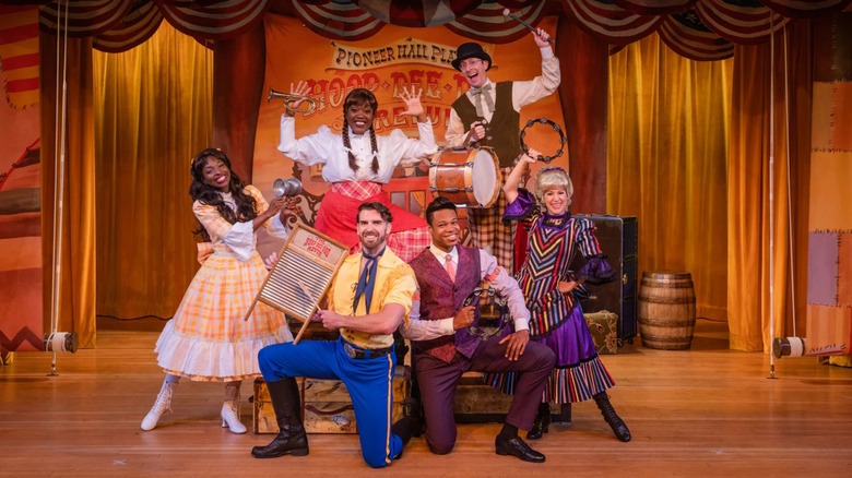 Group of performers on stage at old West-themed stage show