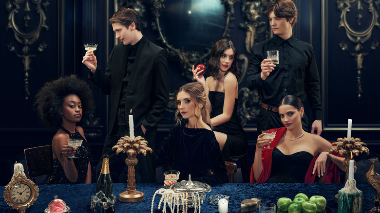 Group of people posting at a 1920s-era dinner table