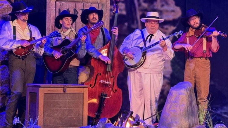 Group of musicians on stage in Western gear