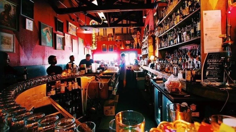Customers drink beer at Poison Girl bar
