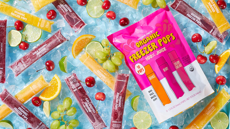 Bag of Trader Joe's Organic Freezer Pops next to ice pops, cherries, grapes, and citrus slices on bed of ice