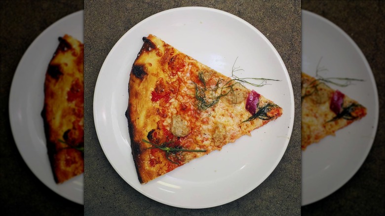 Slice of pizza from Harvest Pizzeria on a white plate