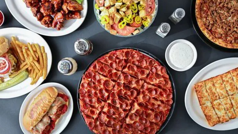 Pizza, salad, and meals from Massey's Pizza on a table