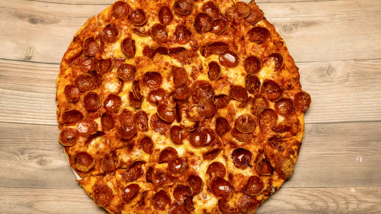 Tommy's pepperoni pizza on a wooden surface